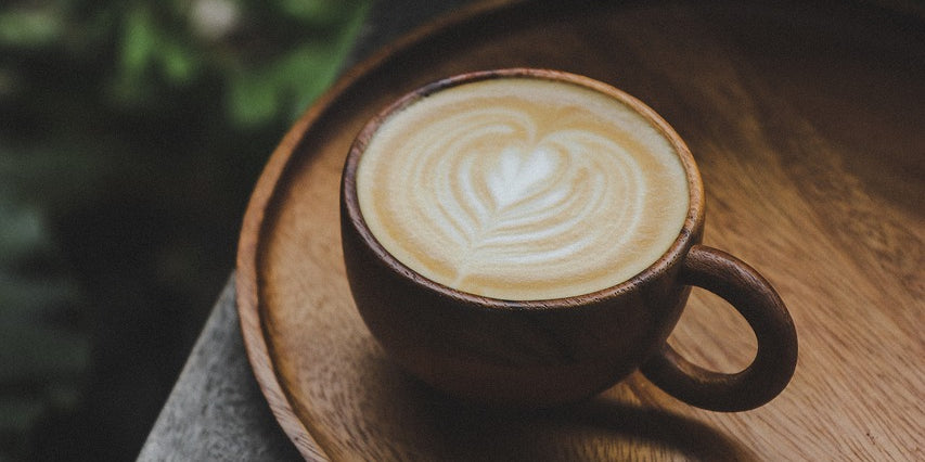 A photograph of a coffee cup on a small table